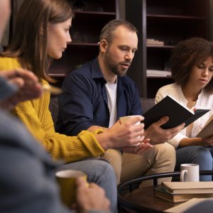 Members of a home group sitting together with open Bibles